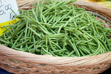 Green string beans in woven basket close-up