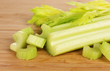 fresh slised green celery on wooden background.