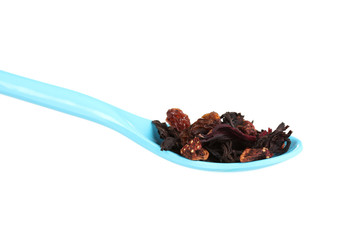 Green dry fruit tea in spoon isolated on white