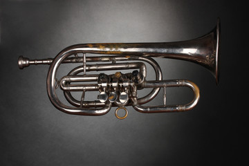 old trumpet on gray background