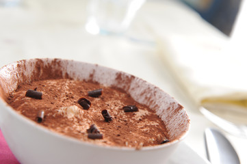 a bowl of tiramisu with a chocolate garnish