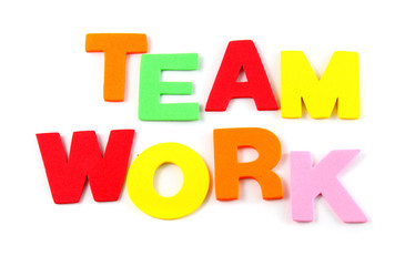 Team work in colorful toy letters on white background