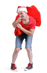 Obraz premium Santa Claus in sneakers with a full bag of gifts