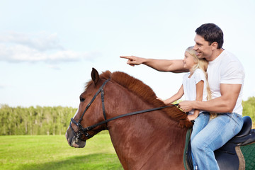 Father and daughter on a horse