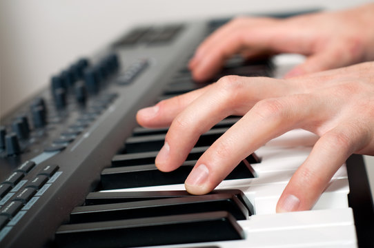 male hands playing the piano