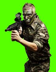 young soldier aiming over removable chroma key background