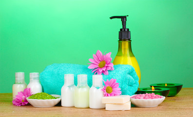 Hotel amenities kit on wooden table on blue background