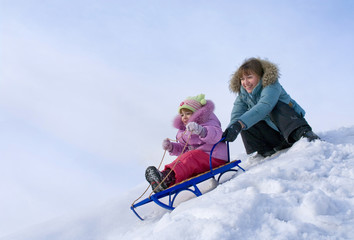 Mother and daughter sledging