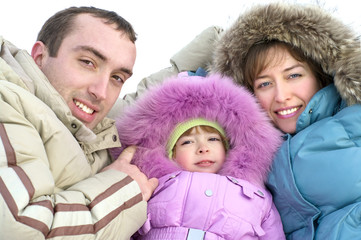 happy young parents with daughter on to snow