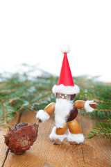 santa claus made of chestnuts,acorns and beechnuts on wooden boa