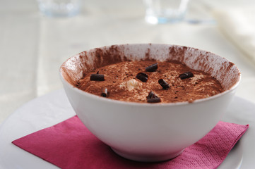 a bowl of tiramisu with a chocolate garnish