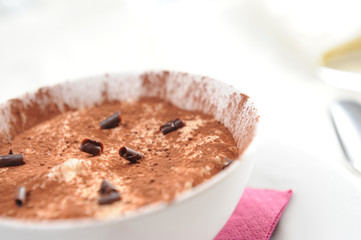 a bowl of tiramisu with a chocolate garnish