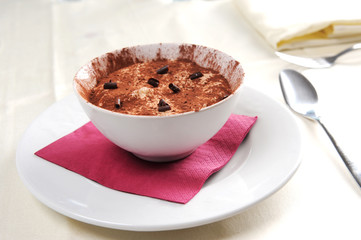 a bowl of tiramisu with a chocolate garnish
