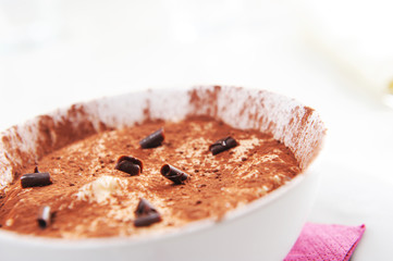a bowl of tiramisu with a chocolate garnish