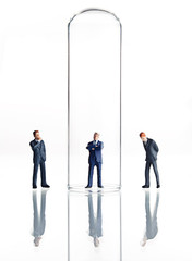 Obraz premium Business figurines placed in and around test tubes