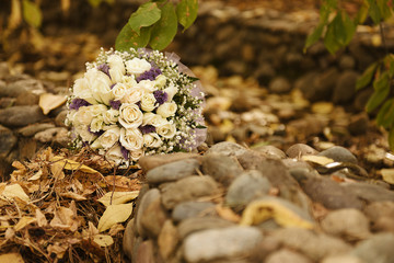 Wedding bouquet lying on stones