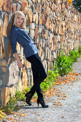 girl near stone wall