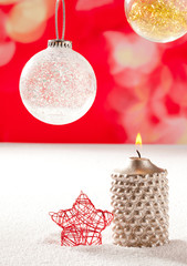 christmas silver candle and red star on snow