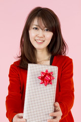 Fototapeta premium Beautiful young woman with gift