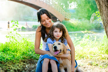 daughter and mother with golden retriever