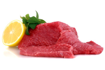 Cut of  beef steak  with lemon slice. Isolated.