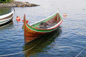 The wooden rowing and sailing boat