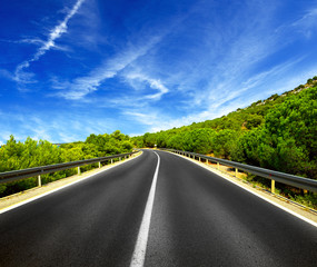 Asphalt road and blue sky with clouds