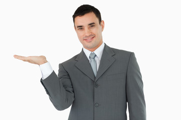 Businessman displaying something in his palm