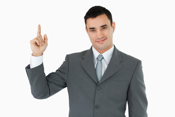 Standing businessman pointing upwads