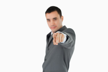 Side view of businessman pointing towards camera