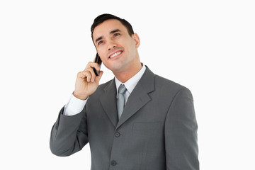 Businessman on the phone looking upwards