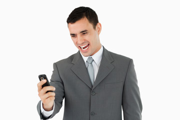 Businessman happy about text message