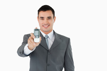 Smiling businessman showing his phone