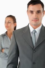 Close up of businessman with colleague behind him