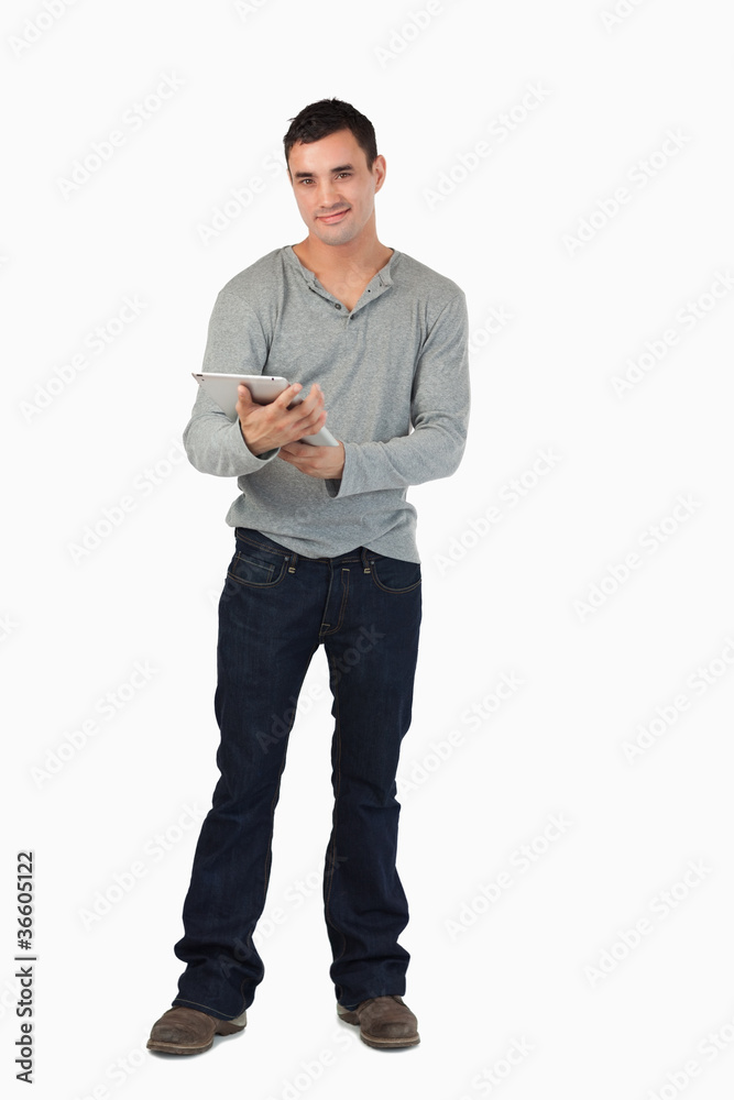 Poster smiling young male using his tablet