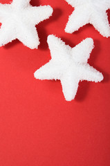 Snow stars on the red with copy space.