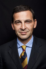 Portrait of confident businessman over black background