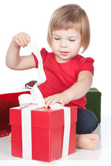 Little girl opening the red gift