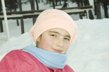 smiling girl in winter sports with snow on background
