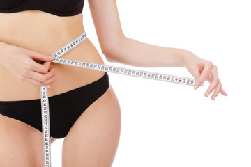woman measures her waist belly, isolated on white background