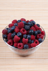 A bowl of fresh raspberries and blueberries