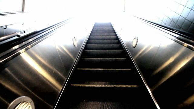 Riding up an escalator into the light