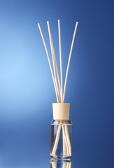 Bottle of air freshener on blue background