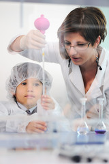 Smart cute little male child  experimenting in lab