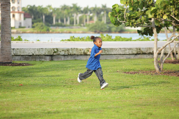 Boy running through the park
