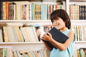 Kid with book in library