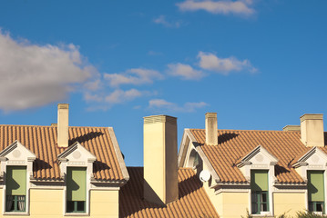 Gable Dormers and Roof of Residential House under a blue sky