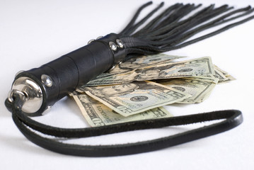 Black Leather Flogging Whip and money on white background. Not i
