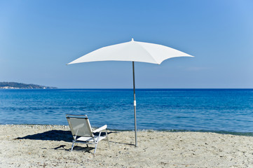 Chair and beach umbrella