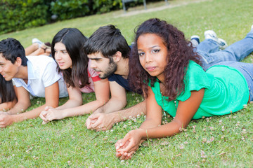 Fototapeta premium Group of Teenagers Lying on the Ground at Park